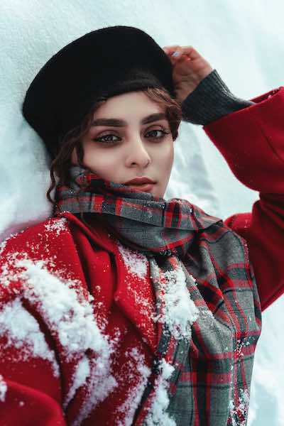 a women lay on snow ground