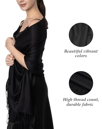 Black scarf with fringe details on a white background, featuring text about fabric quality.